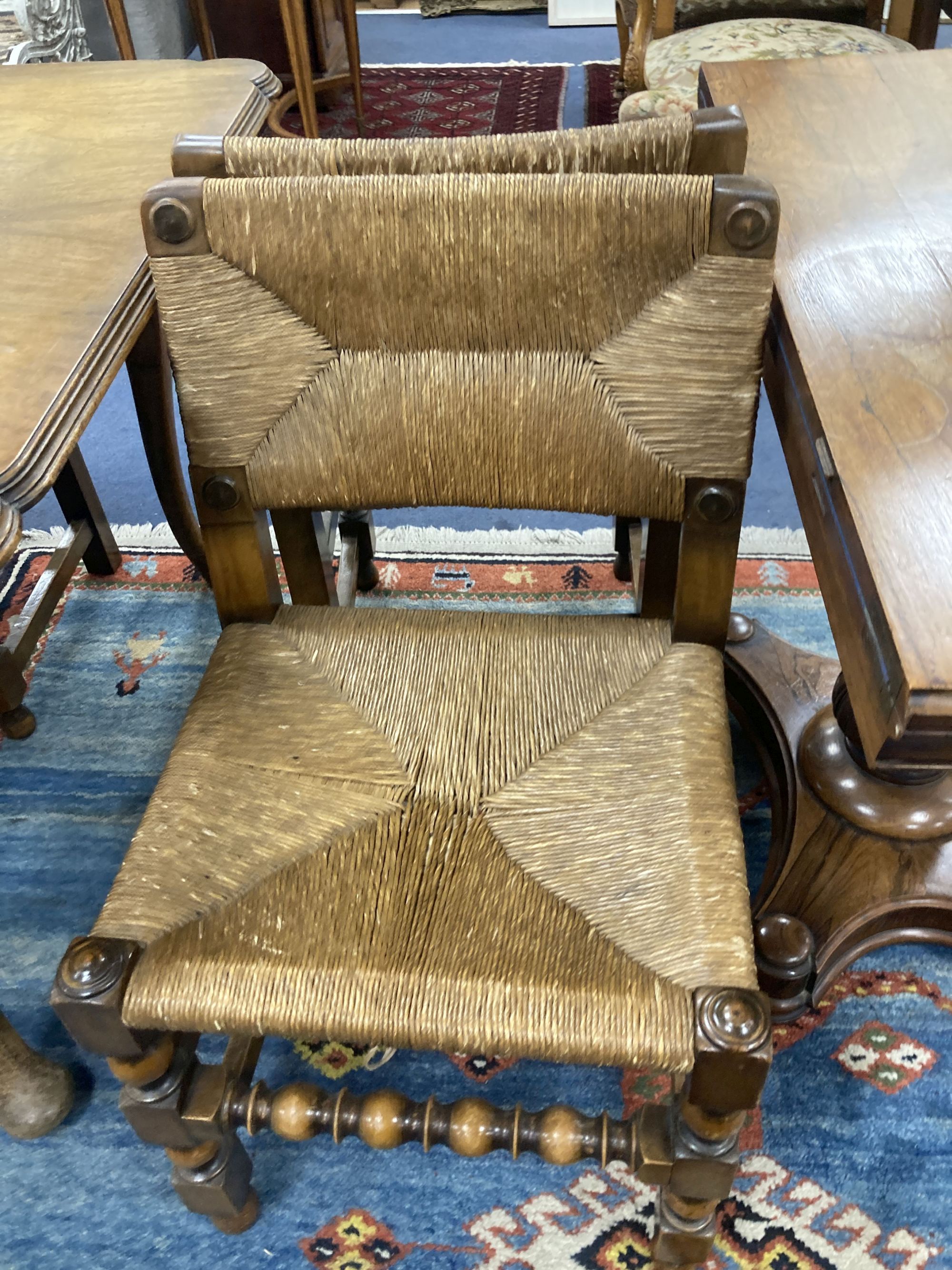 A set of eight turned beech dining chairs with rush seats and backs (two with arms)